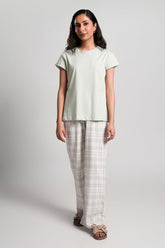 Toren – LaRosa Night Wears for Women – Cotton Summer Sets Collection | Larosawears | Shop Online – Front View.
Woman wearing a light green t-shirt and checkered pants on a white background